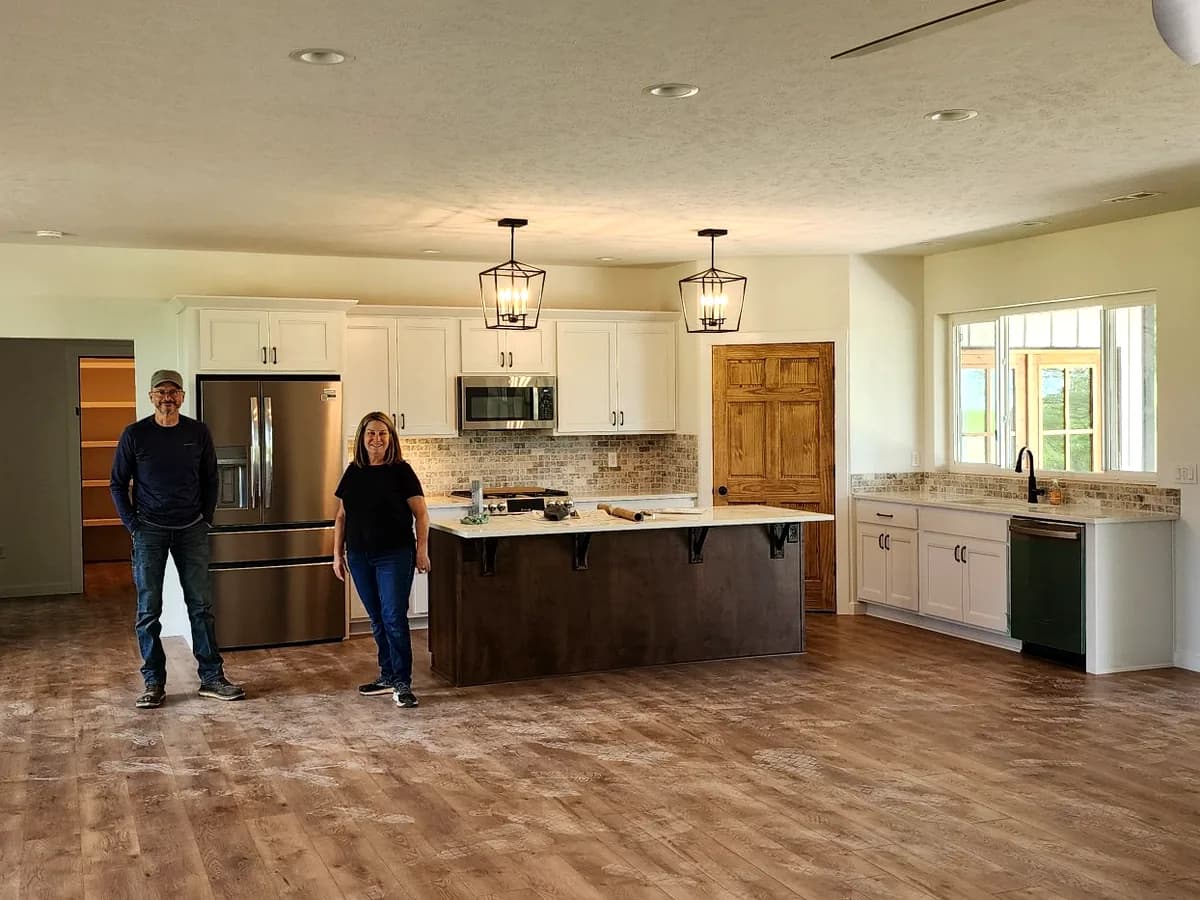Open kitchen with island, pendant lights, and custom cabinetry