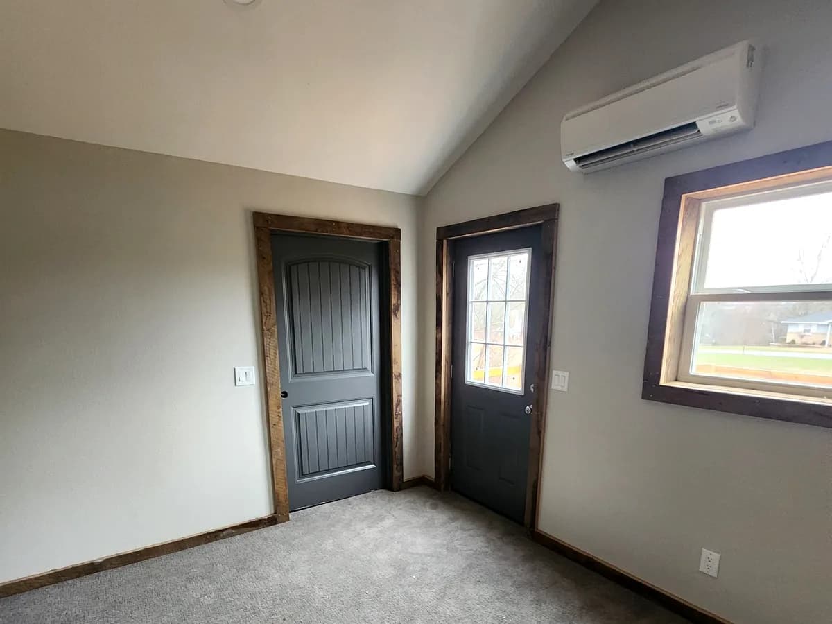 Vaulted bedroom with rustic wood trim and mini-split HVAC